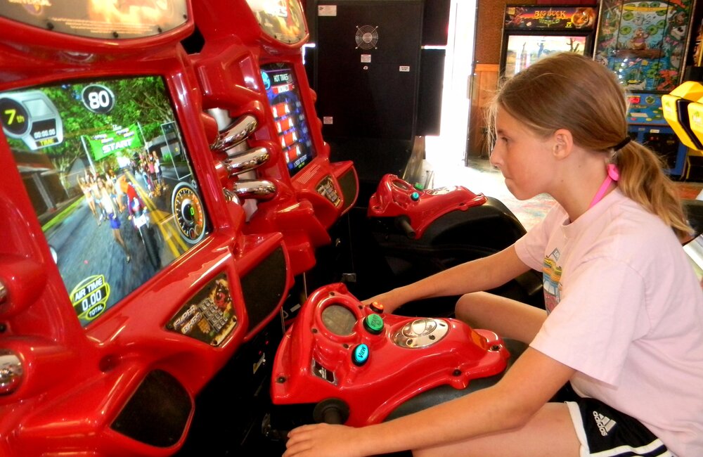 Maddie Ballerini, 11, of Harwinton, Connecticut, concentrates during her high-speed adventure on the "Super Bikes" at the Fun World arcade in Lake George. The arcade offers 100 games for people who like video, pinball and athletic challenges. Jeff Wilkin photo  